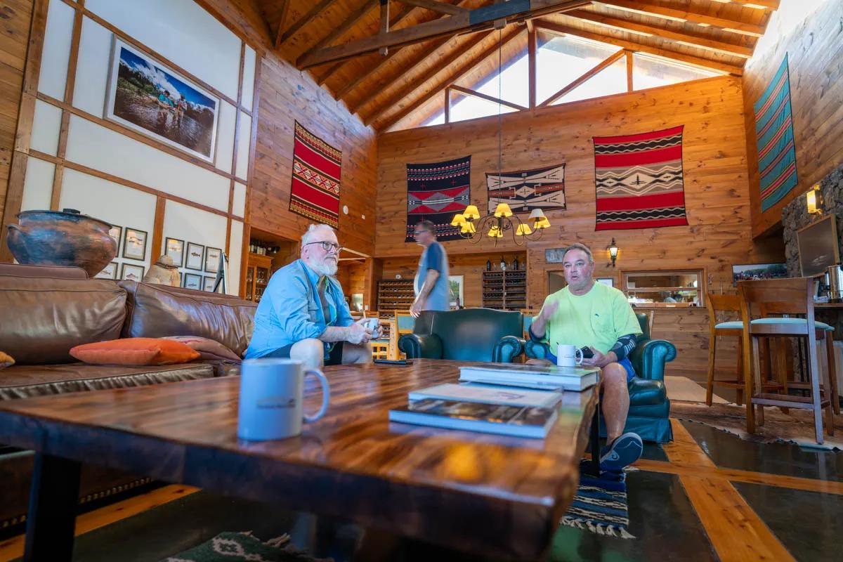 Guests relax in the great room at Carrileufu River Lodge during Montana Angler's 2024 hosted trip.