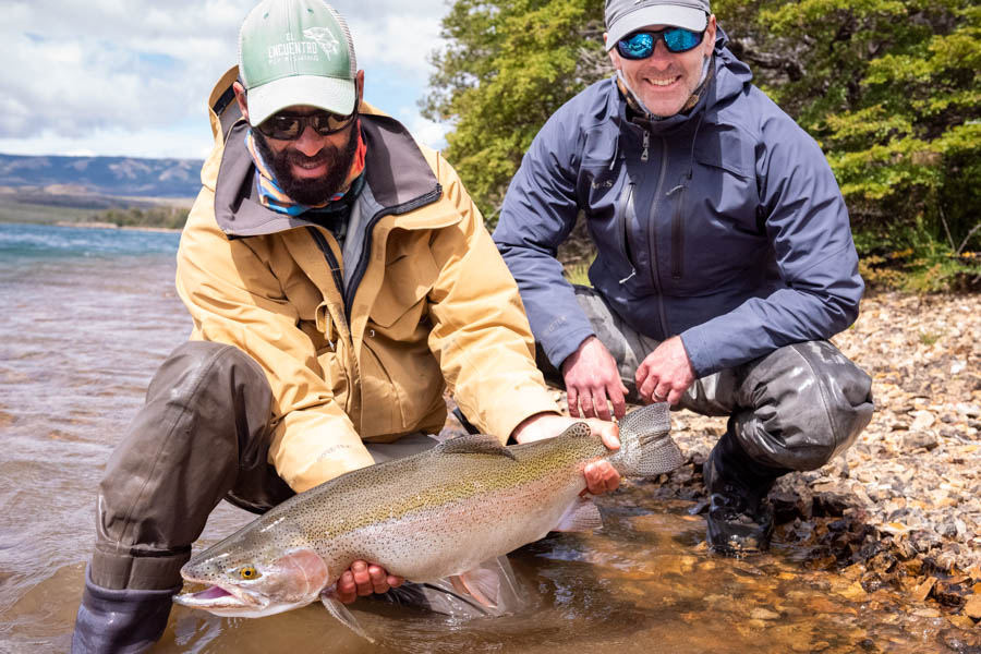 Marcello, left, holds a massive Lago Dos rainbow trout caught by Corey