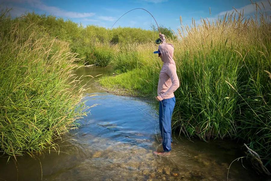 Hooked up while fishing a bamboo rod on a small stream Hooked up while fishing a bamboo rod on a small stream