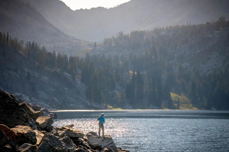 Casting beneath the shadow of towering peaks for native trout in remote country is a pinnacle experience for any angler