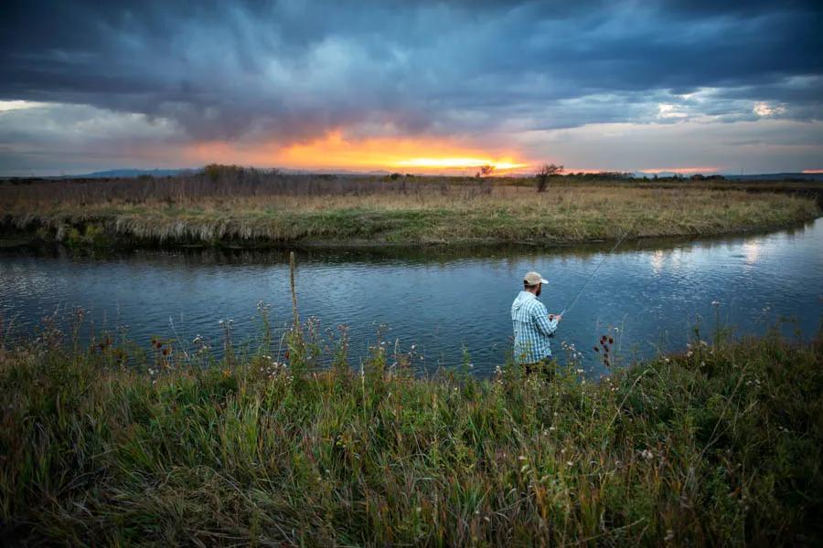 An angler fishing at last light on the East Gallatin River