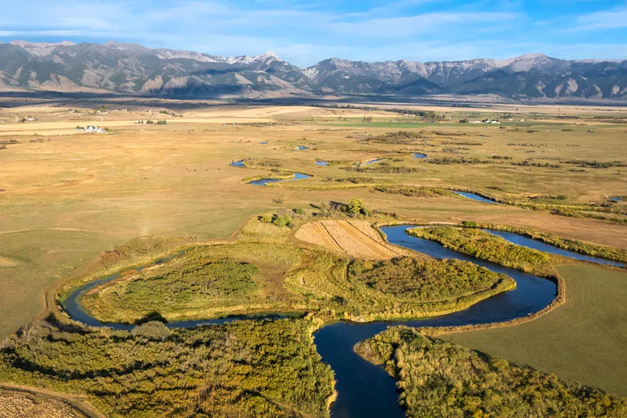 The East Gallatin River flows below the Bridger Mountain Range north of Bozeman, Montana