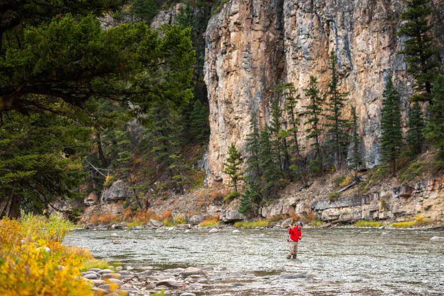 Shear cliff faces greet anglers fishing the Gallatin River in Gallatin Canyon