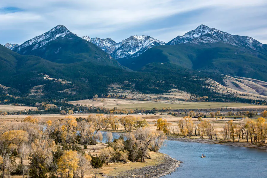 Anglers fish the Yellowstone River beneath the towering peaks of the Absaroka Mountains