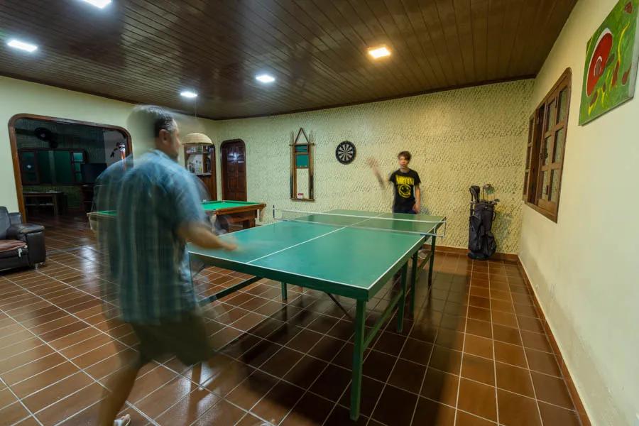 Enjoying a fierce match of ping pong in the lodge's game room before dinner