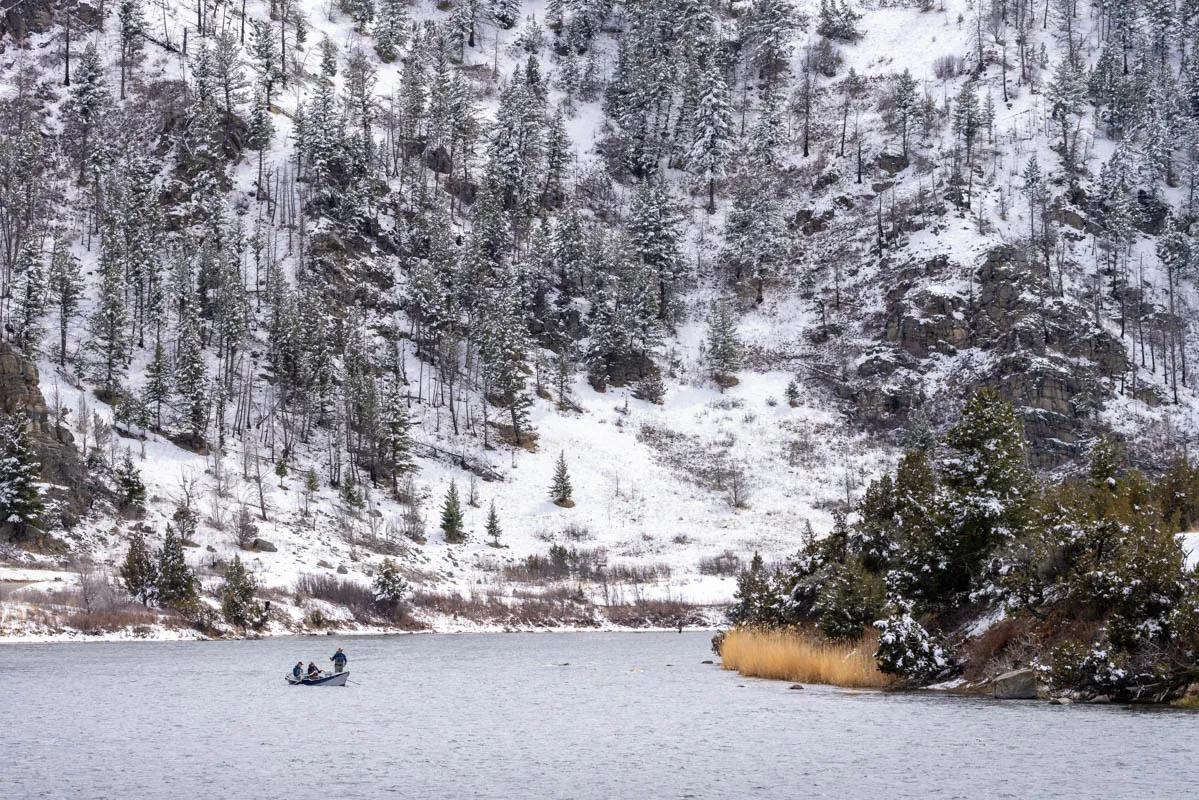 Anglers fish the midge hatch from a drift boat in Bear Trap Canyon on the lower Madison River