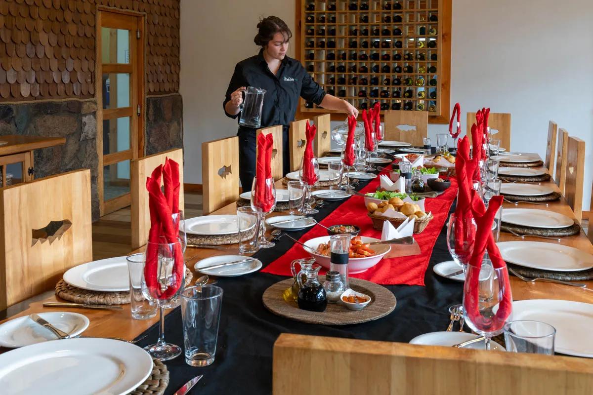 Valentina puts the finishing touches on a beautiful table setting before dinner at the lodge