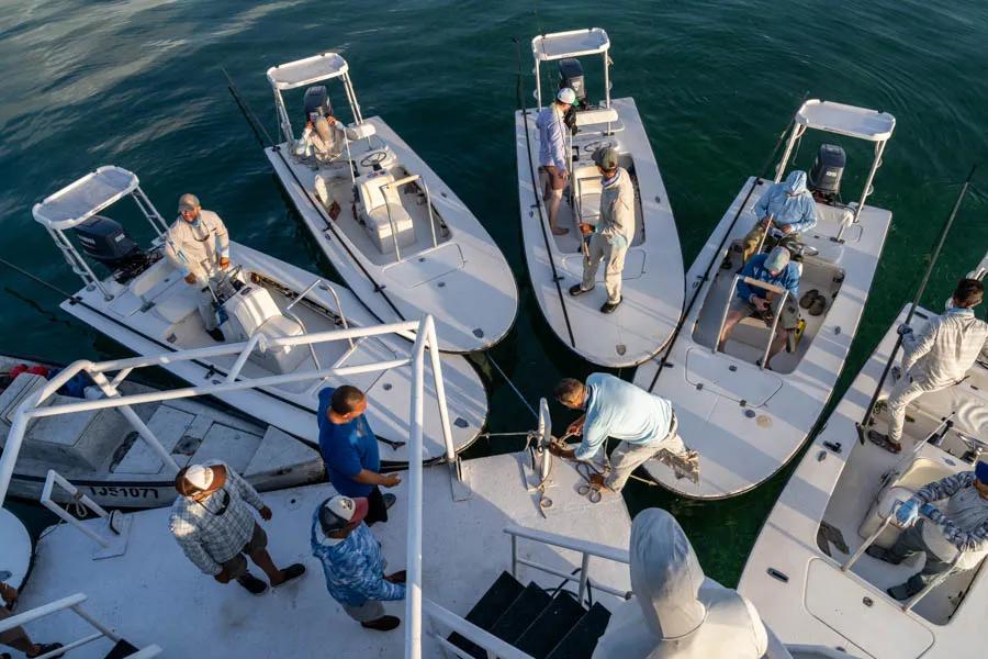 Guides gather in Cuba Each morning 6 skiffs arrive at the mother ship before the day begins. The experienced guides are mostly from the larger island to the West (the Isla de Juventud) and most of them have spent most of their lives exploring these waters.