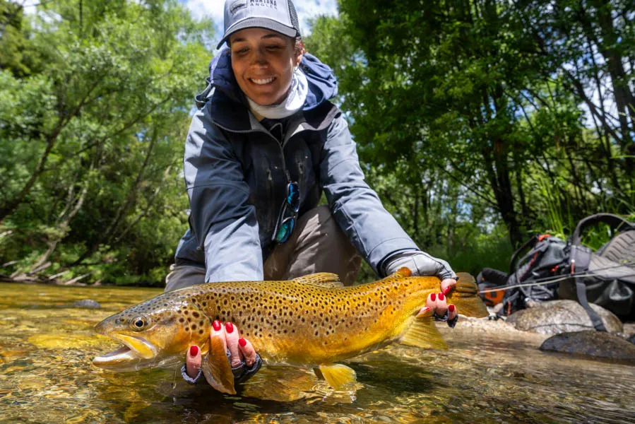 Ann with nice brown trout in New Zealand
