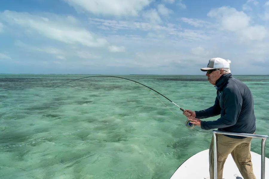 Montana Angler Cuba fly fishing trips. Even on the one cloudy and windy day, our group of anglers were able to find schools of large bonefish to provide some action despite the conditions and desire to cast to the elusive permit. Tim Foster lands a nice bonefish from one of the schools of a hundred fish.
