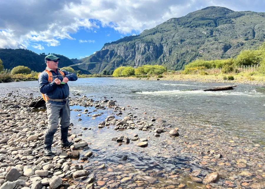 Montana Angler fly fishing trips to Patagonia On the first day, despite heavy rains at the lodge, the guides knew where to go to find clear skies and clear water. Here, I'm hooked into a massive king salmon.