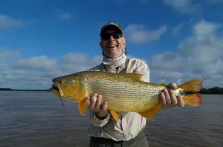 Happy angler with a Golden Dorado