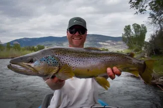 Happy angler with a giant brown trout