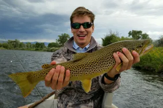 Happy angler with a brown trout