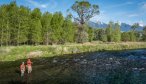 An angler and guide present to rising trout on Armstrong Spring Creek