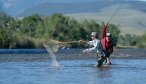 A guide helps net a rainbow trout