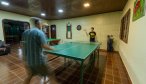 Enjoying a fierce match of ping pong in the lodge's game room before dinner