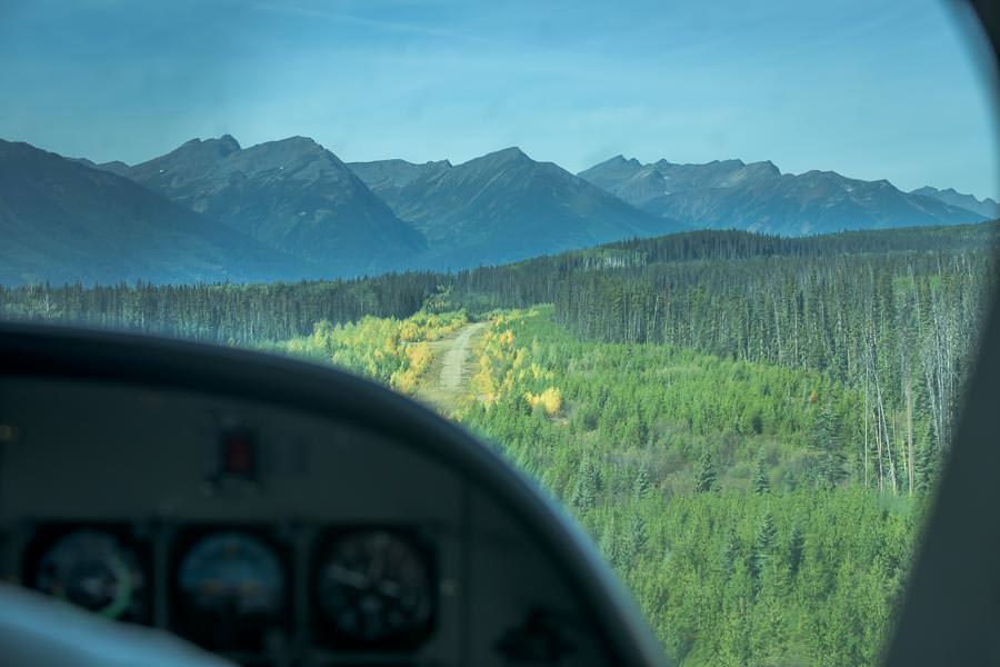 The tiny dirt runway hidden in the trees