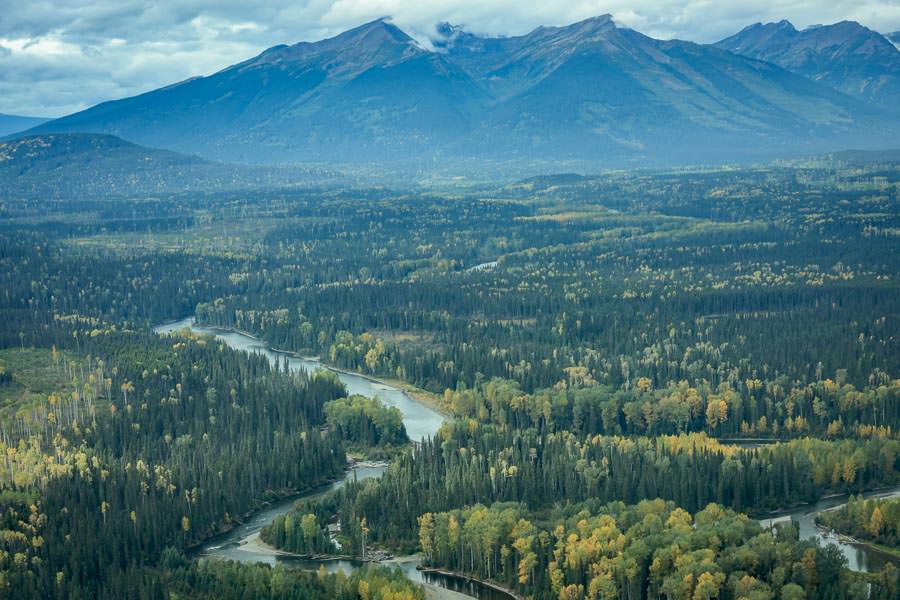 Glacier peaks giving way to broad river valleys Glacier peaks giving way to broad river valleys