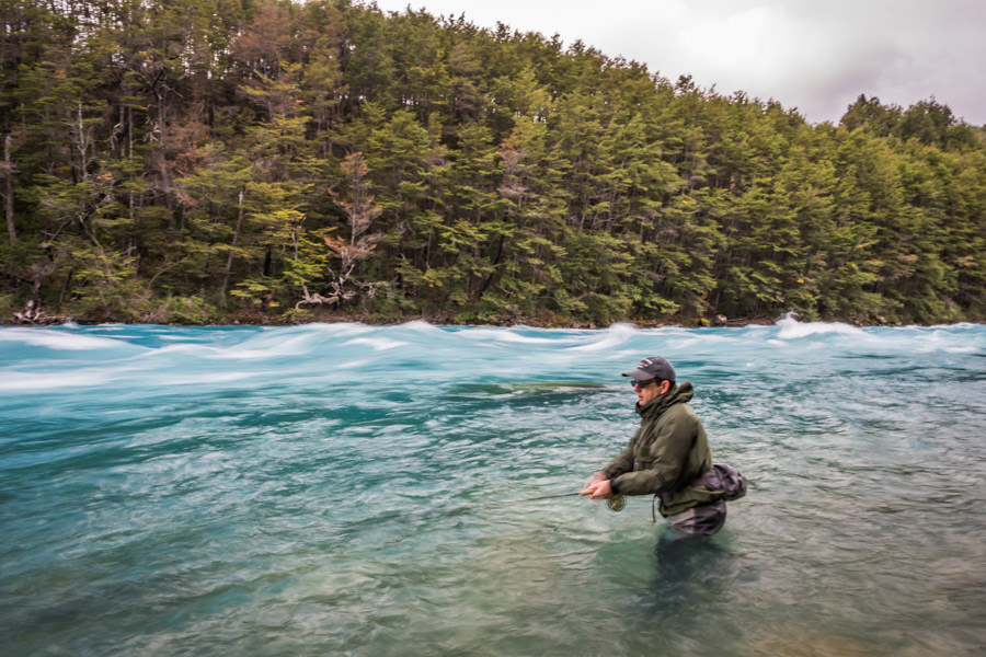 Wading the fast water of the Baker River in Chile