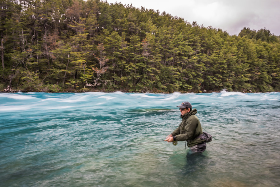 Wading the fast water of the Baker River in Chile Wading the fast water of the Baker River in Chile