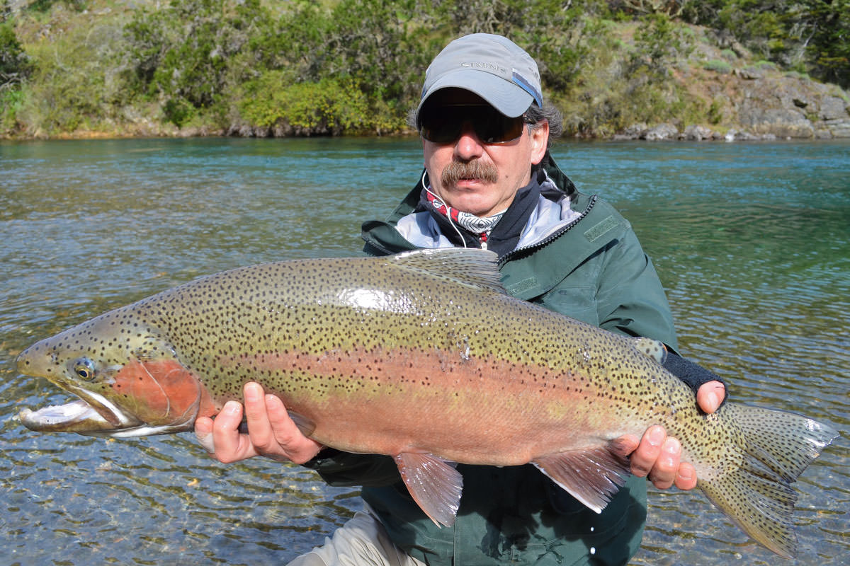 You can bet this lucky angler saw some backing when he caught this giant rainbow on one of our hosted Chilean fly fishing trips!