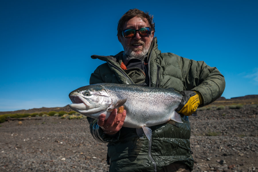 My fishing partner for the week, Roberto from Buenos Aires, with a "chromer" from Cochinos Bay. The alkaline nutrients of the lake produce a chrome bright color to the lake rainbows