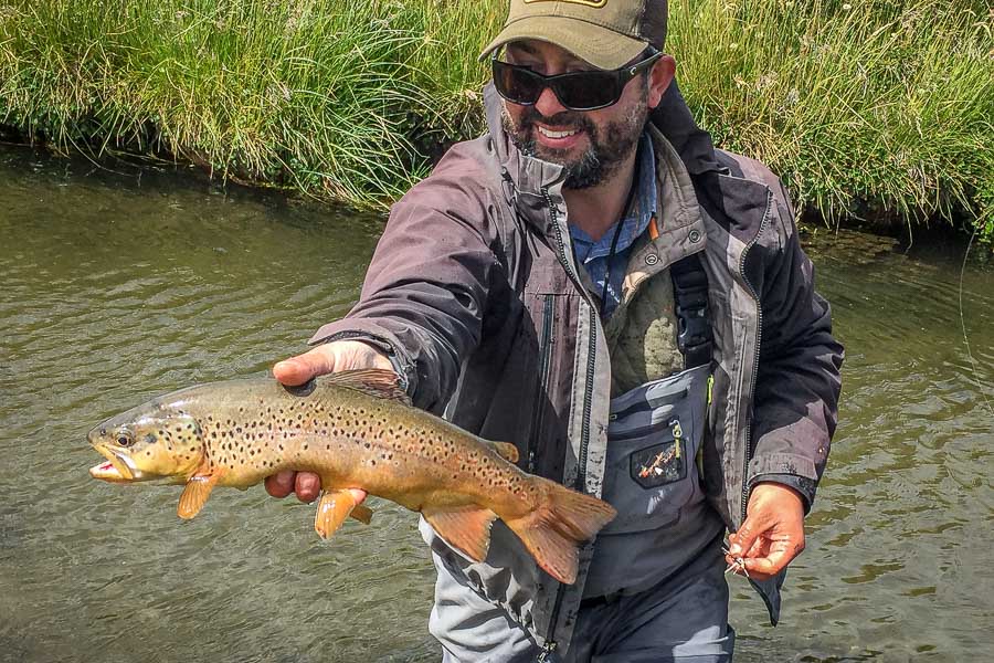 Lodge owner and outfitter Eduardo shows off a spring creek brown that crushed a dry fly