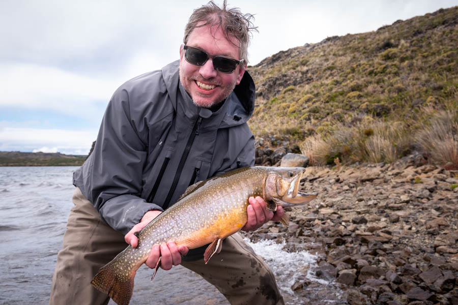 Phil holds a trophy brook trout caught while fishing Lago Dos