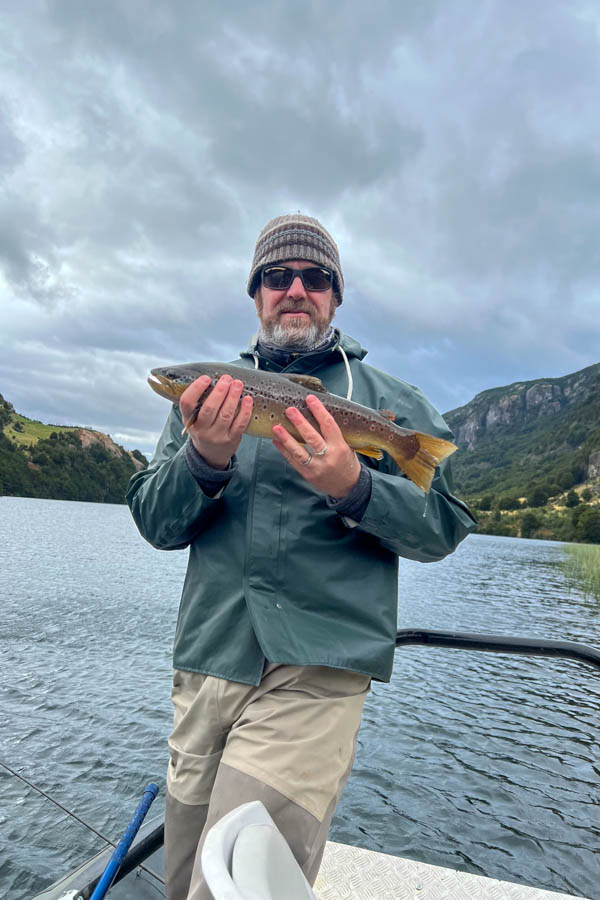 Lake fishing in the Coyhaique area can be exceptional with trout often willing to rise to dry flies. John holds a brown caught while fishing on one of the area Stillwaters