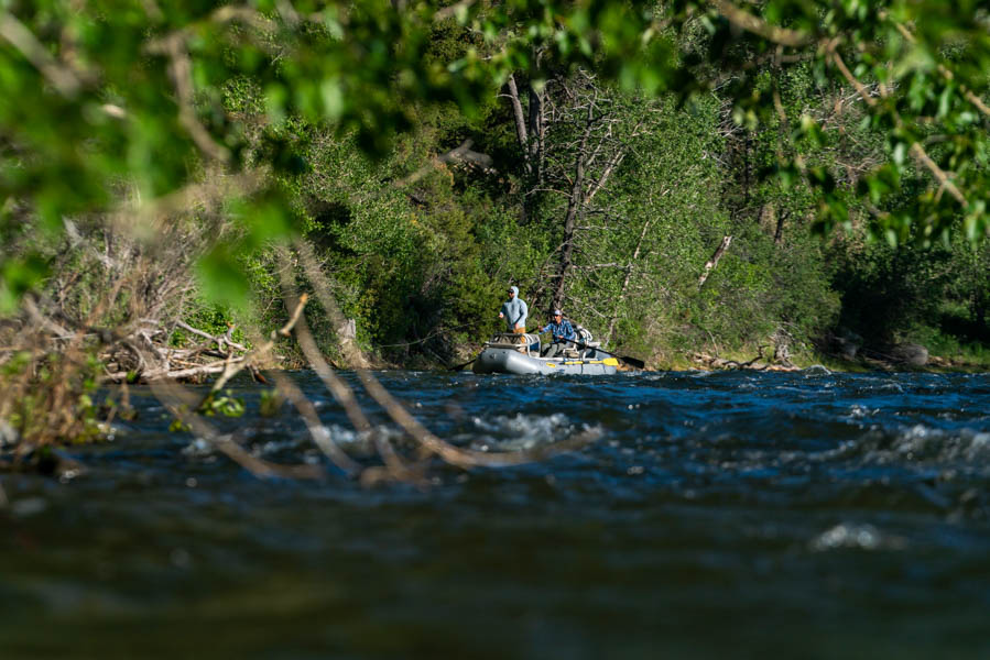 An angler casts from a raft on the Boulder River near McLeod, Montana