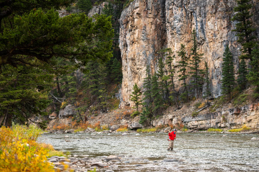 Shear cliff faces greet anglers fishing the Gallatin River in Gallatin Canyon Shear cliff faces greet anglers fishing the Gallatin River in Gallatin Canyon