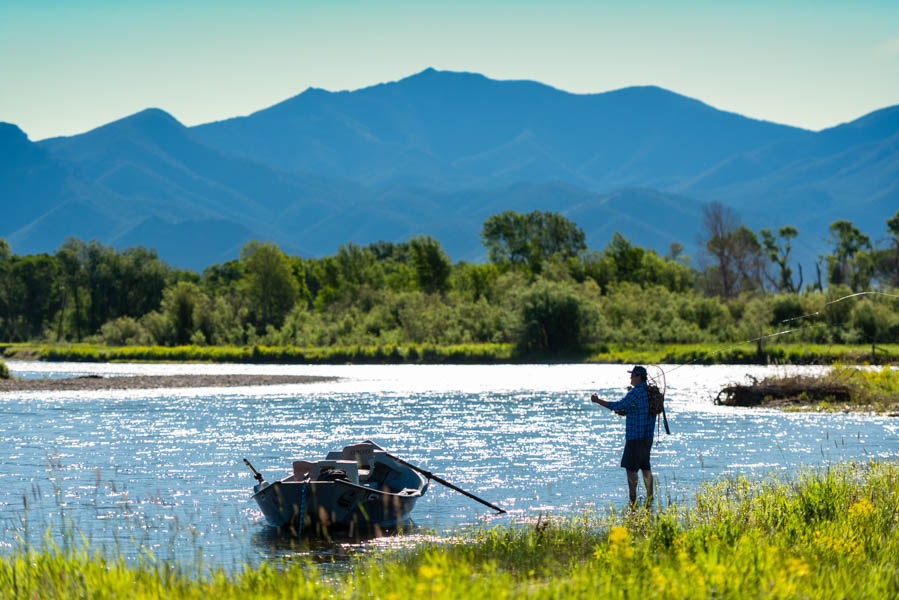 An angler fishes the Jefferson River beneath the peaks of the Tobacco Root Mountains